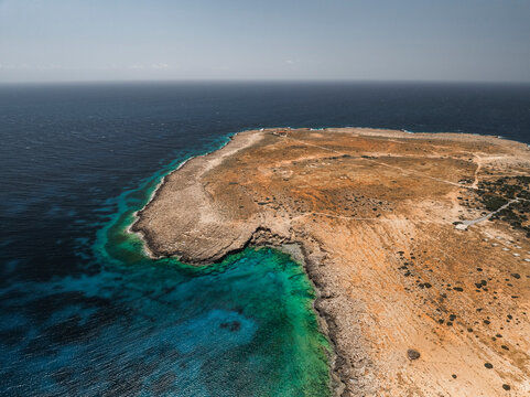 Aerial view of blue lagoon at Cape Greco Peninsula with clear water and beautiful coastline, Agia Napa, Famagusta, Cyprus.