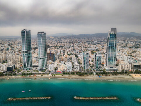 Aerial view of modern urban skyline with high-rise buildings along the coastline and beach, Limassol, Limassol, Cyprus.