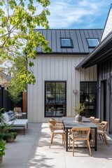 Modern outdoor dining area featuring a stylish table and chairs, surrounded by greenery in a contemporary home setting, showcasing a combination of natural light and modern architecture