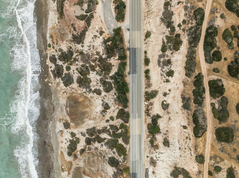 Aerial view of aphrodite beach with serene waves and picturesque coastline, Kouklia, Paphos, Cyprus.