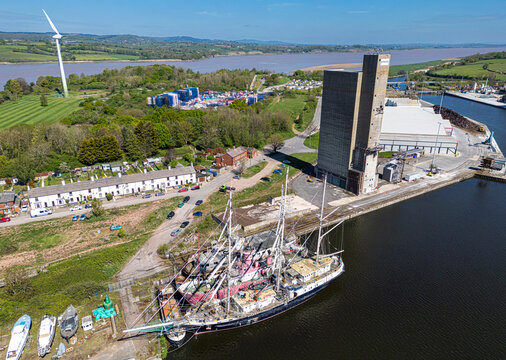 Aerial view of Sharpness dock with schooners and wind turbines amidst a beautiful urban landscape, Sharpness, Berkeley, England, United Kingdom.