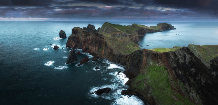 Aerial view of dramatic coastline with rugged cliffs and serene ocean waves, Canical, Madeira, Portugal.