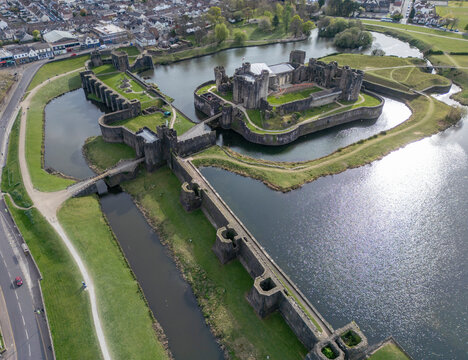 Aerial view of caerphilly castle surrounded by a scenic moat and lush greenery, Caerphilly County Borough, Wales, United Kingdom.
