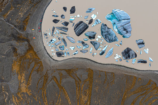 Aerial view of beautiful glacier lake surrounded by melting ice and snow, H^fn, Southern Region, Iceland.