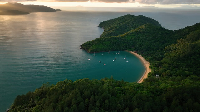 Aerial view of lush tropical archipelago with islands and sailboats at sunrise, Parque Das Palmeiras, Angra dos Reis, Rio de Janeiro, Brazil.