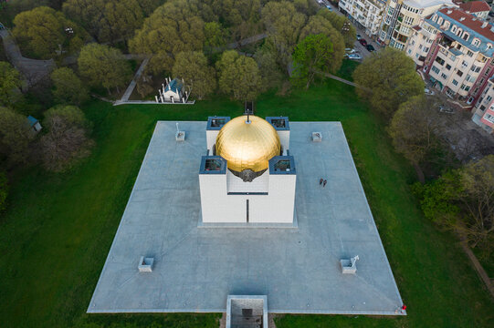 Aerial view of pantheon of national revival heroes with golden dome surrounded by park and trees, Ruse, Ruse, Bulgaria.