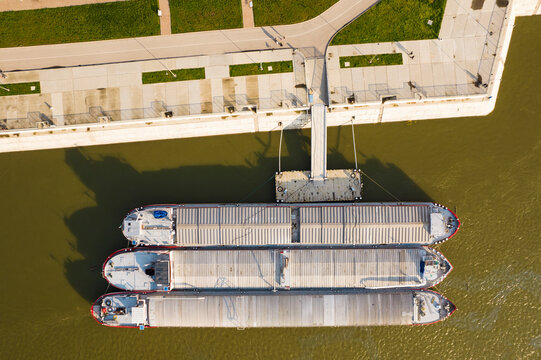 Aerial view of colorful cargo barges on the Danube river near Coastline Park, Ruse, Ruse, Bulgaria.