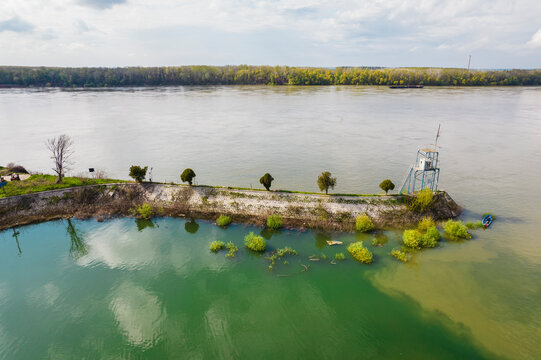 Aerial view of the tranquil Danube river with lush trees and serene riverbank, port of Ruse west, Ruse, Bulgaria.