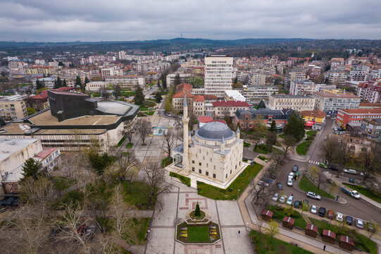 Aerial view of the historic ibrahim pasha mosque surrounded by urban buildings and greenery, Razgrad, Bulgaria.
