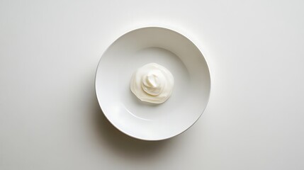 A dollop of whipped cream in a white bowl