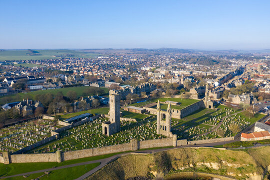 Aerial view of historic St Andrews Cathedral and St Rules Tower surrounded by lush greenery and ancient ruins, St Andrews, Fife, Scotland.