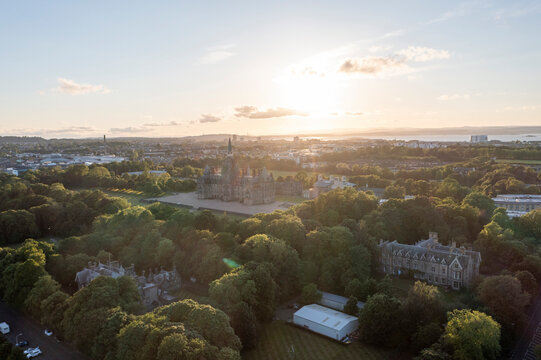 Aerial view of Fettes Public School amidst beautiful trees and a picturesque cityscape at sunset, Comely Bank, Midlothian, Scotland.