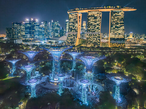 Aerial view of glowing super trees and marina bay sands in night time, Singapore.