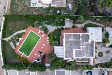 Polignano A Mare, Italy - 23 September 2024: Aerial view of luxurious villa with a scenic pool and lush garden, Polignano a Mare, Bari, Italy.
