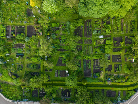 Aerial view of lush allotments and gardens with organized plots and greenery, Dean Village, Midlothian, Scotland. - Powered by Adobe
