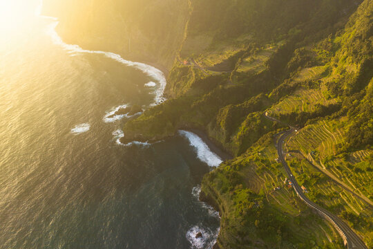 Aerial view of breathtaking coastline with rugged cliffs and serene ocean waves, Madera, Portugal.