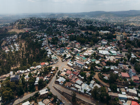 Aerial view of beautiful urban landscape with residential buildings, roads, hills, and trees, Debre Birhan, Amhara, Ethiopia.