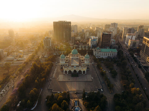 Aerial view of Medhane Alem Cathedral at sunrise with a beautiful urban skyline, Ghiliffalegn Stream, Addis Ababa, Ethiopia.