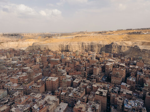 Aerial view of the densely populated urban landscape with buildings and rooftops in Mansheya Nasir, The Garbage City, Cairo, Egypt.