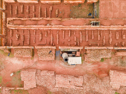Aerial view of organized rows of red bricks in a brick field, Islampur, Bangladesh.