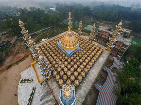 Aerial view of the beautiful 201 Dome Mosque surrounded by lush trees and scenic landscape, Gopalpur, Bangladesh.