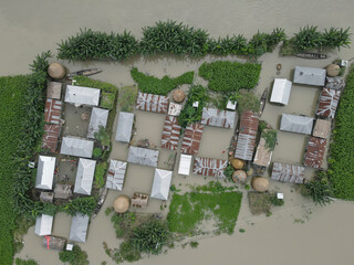 Aerial view of flood water affecting homes and boats in a village, Jatrapur, Kurigram, Bangladesh.