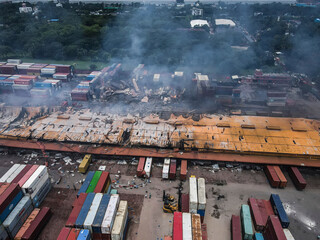 Sitakunda, Bangladesh - 05 June 2022: Aerial view of the aftermath of a devastating fire at BM Container Depot with smoke and wreckage, Sitakunda, Bangladesh.
