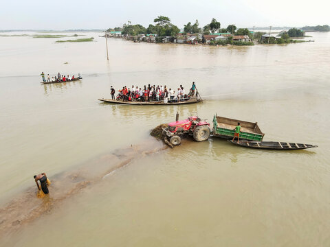 Tahirpur, Bangladesh - 16 May 2022: Aerial view of flooded villages with boats and people in a natural landscape, Uttar Badaghat, Tahirpur, Bangladesh.