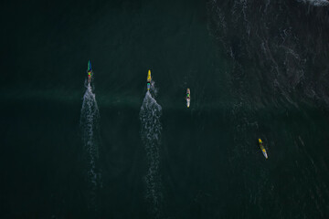 Aerial view of people paddle boarding in the beautiful ocean, Mandurah, Australia.