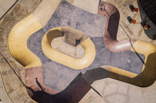 Aerial view of a dynamic and abstract skatepark with geometric patterns and shadows, Halls Head, Australia.