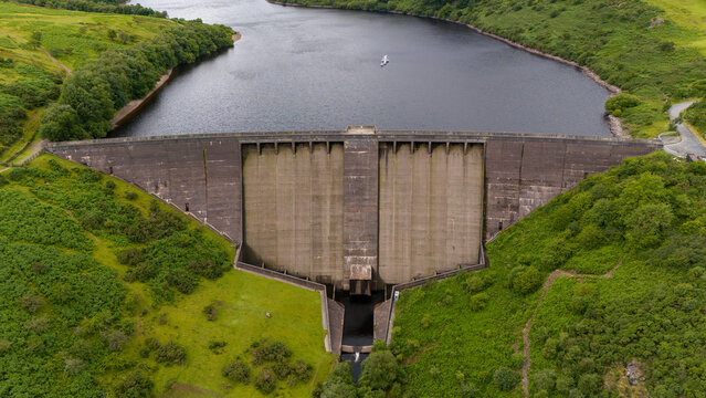 Aerial view of meldon viaduct and reservoir surrounded by lush greenery in a tranquil valley, Okehampton, United Kingdom.