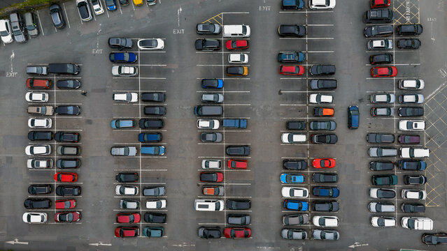 Aerial view of organized carpark with modern cars in a geometric pattern, Tavistock, England.