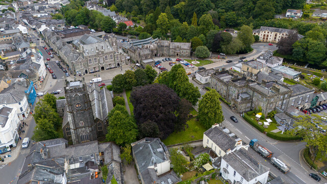 Aerial view of historic pannier market and charming streets surrounded by greenery and traditional buildings, Tavistock, England.