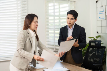 Document Review. Business professionals discussing project papers.