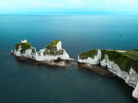 Aerial view of the iconic landmark of Old Harry Rocks and its white cliffs made of chalk in Studland, Dorset, United Kingdom.