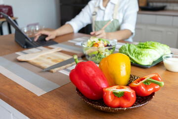 young woman preparing bell Pepper as a breakfast ingredient and ready for healthy cooking and on the table there are vegetables that are healthy organic ingredients. healthy food preparation ideas