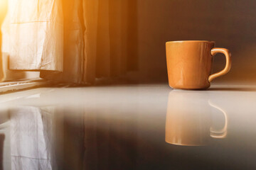 Smooth Focus and soft Focus,Hot coffee in a cup of coffee placed on the bedroom floor by the window in the morning was placed to prepare for drinking coffee before work.