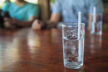cold water inside glass placed on dining table is prepared for customers drink while eating or as drinking water while waiting for their orders. Concept of preparing drinking water ready for customers