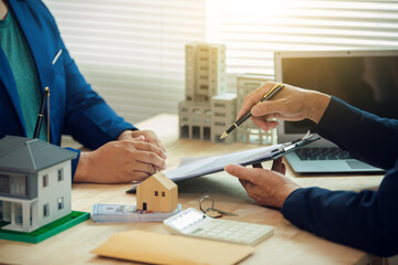 Businessman, house and condo sales representative Hand over the keys to the customer and sign the...