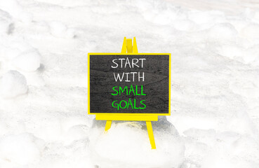 Start with small goals symbol. Concept words phrase Start with small goals on beautiful black...
