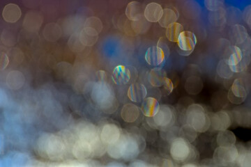 Abstract background blur with bokeh light circles in tints of blue 
