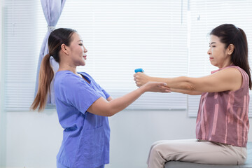 female doctor is taking care of an elderly person and helping elderly person do physical therapy help muscles work and check function of muscle system when elderly person starts recover from injury.
