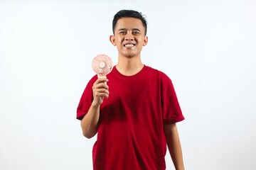 Asian man holding mini portable fan isolated on white background