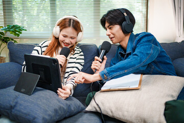 Online podcast planning with young man and woman using tablet and microphones