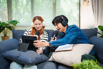 Online podcast planning with young man and woman using tablet and microphones