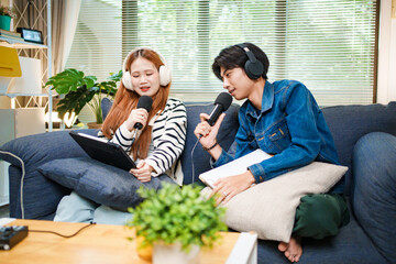 Online podcast planning with young man and woman using tablet and microphones