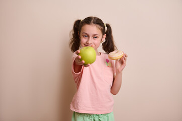 Young Girl Holding a Green Apple and a Doughnut Expressing Choices in Healthy Eating and Indulgence