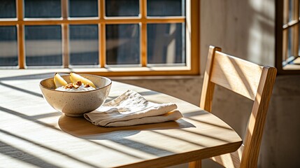 Bright, clean arrangement of yogurt with pear slices and roasted hazelnuts in a pale ceramic bowl, styled with a folded natural linen napkin, shadows falling gently across a concrete tabletop