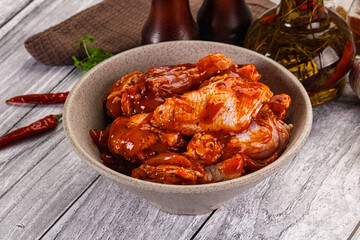 Raw marinated buffalo chicken wings