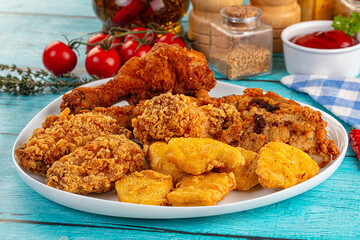 Golden crispy fried chicken mix - wings, drumsticks, nuggets and strips